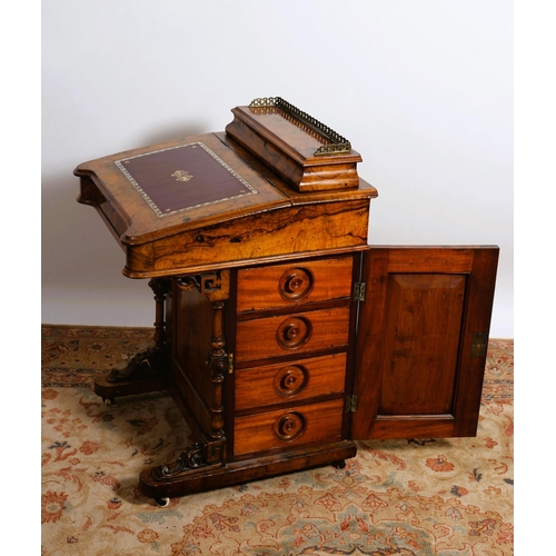 8 - A VICTORIAN WALNUT DAVENPORT the superstructure with hinged compartment and pierced brass gallery ab... 
