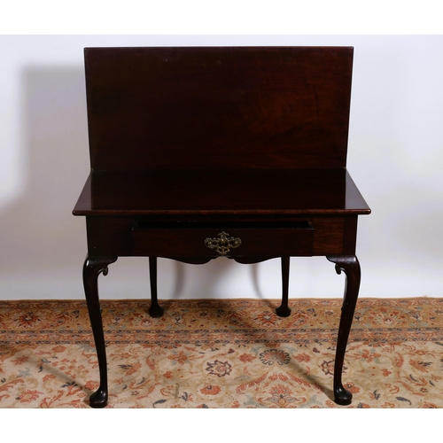 82 - AN IRISH GEORGIAN MAHOGANY FOLDOVER SUPPER TABLE the rectangular hinged top with frieze drawer on ca... 