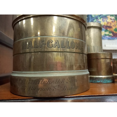 119 - SIX COPPER MEASURES inscribed Half Gallon 'R.G. Catchell & Son 7 Dawson Street Dublin' 40cm (h) x 16... 