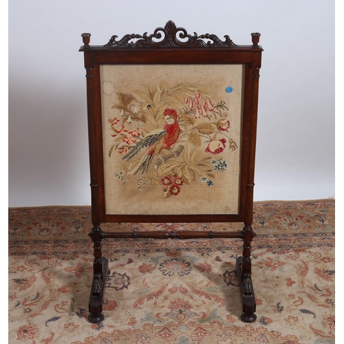 217 - A 19TH CENTURY ROSEWOOD FIRESCREEN the rectangular frame with pierced C-scroll and foliate cresting ... 