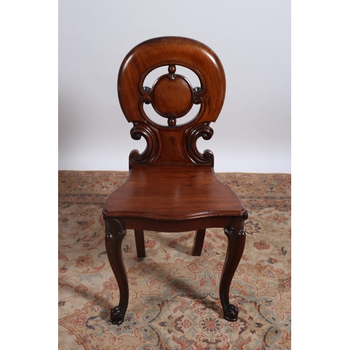 218 - A 19TH CENTURY MAHOGANY HALL CHAIR the oval pierced scroll back with shaped seat on cabriole legs wi... 