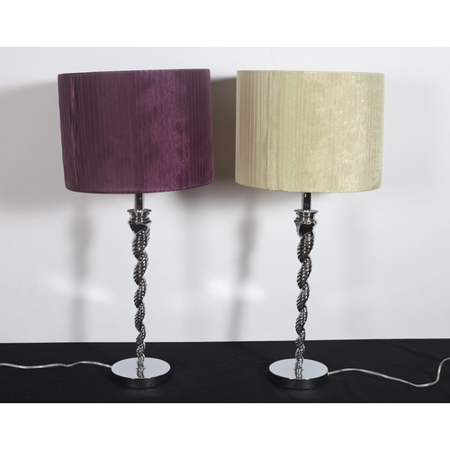 261 - A PAIR OF CONTINENTAL CHROME TABLE LAMPS each with a spiral twist column above a circular foot with ... 