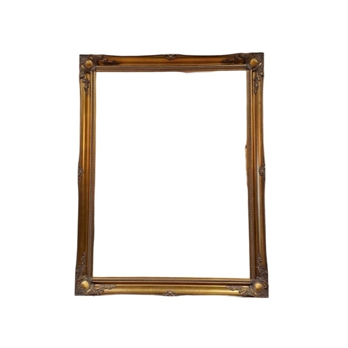 293 - A CONTINENTAL GILT FRAME MIRROR the rectangular bevelled glass plate within a foliate and flowerhead... 