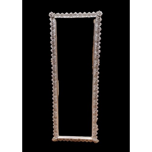 294 - A CONTINENTAL SILVER FRAME MIRROR the rectangular bevelled glass plate within a stylised foliate mou... 