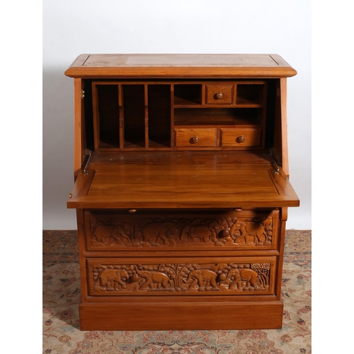 360 - AN ORIENTAL HARDWOOD BUREAU the rectangular top above a carved panel hinged writing slope containing... 