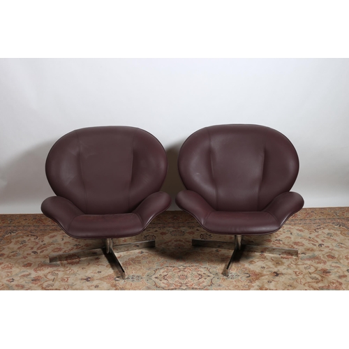 394 - A PAIR OF DESIGNER HIDE UPHOLSTERED AND CHROME REVOLVING CHAIRS each with a shaped back and seat on ... 