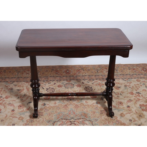 402 - A 19TH CENTURY MAHOGANY FOLDOVER SUPPER TABLE the rectangular hinged top raised on a baluster suppor... 