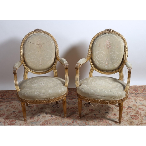 403 - A PAIR OF 19TH CENTURY GILTWOOD AND UPHOLSTERED ELBOW CHAIRS each with a ribbon tied cresting above ... 