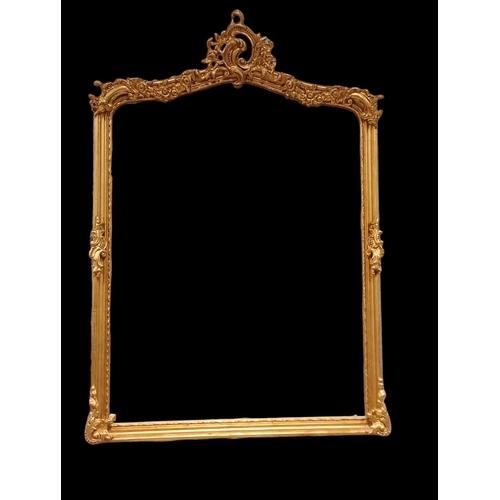 407 - A CONTINENTAL GILT FRAME MIRROR the shaped bevelled glass plate within a moulded frame with stylised... 