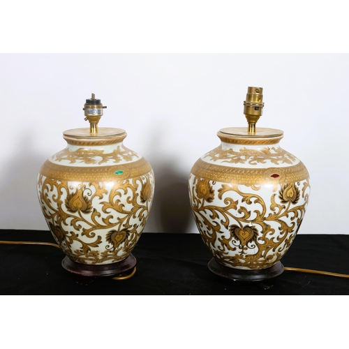 743 - A PAIR OF CONTINENTAL CHINA TABLE LAMPS each of bulbous form the white and gilt ground raised on a h... 