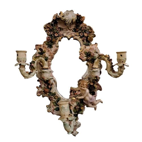 734 - A 19TH CENTURY CONTINENTAL FLOWER ENCRUSTED GIRANDOLE MIRROR the shaped bevelled glass plate within ... 