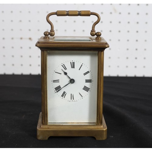 464 - A FRENCH BRASS CARRIAGE CLOCK with enamel dial and Roman numerals on bracket feet
14cm (h) x 9cm (w)... 