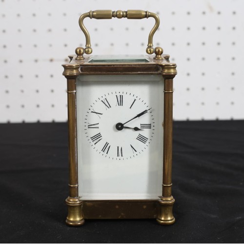 464 - A FRENCH BRASS CARRIAGE CLOCK with enamel dial and Roman numerals on bracket feet
14cm (h) x 9cm (w)... 