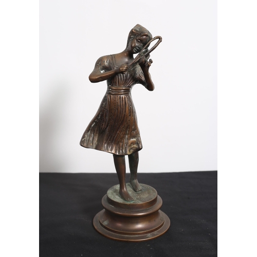 467 - A CAST BRONZE FIGURE modelled as a female shown standing playing the violin raised on a circular spr... 