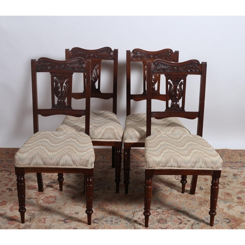 656 - A SET OF FOUR EDWARDIAN CARVED MAHOGANY DINING CHAIRS each with a shaped top rail with foliate carve... 