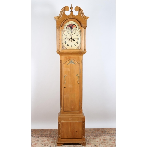 740 - A PINE LONG CASED CLOCK the swan neck pediment above a rectangular arched door containing a painted ... 