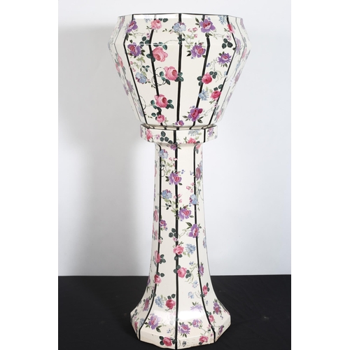 102 - A VINTAGE GLAZED CHINA JARDINIERE ON PEDESTAL of octagonal outline the white ground with floral deco... 