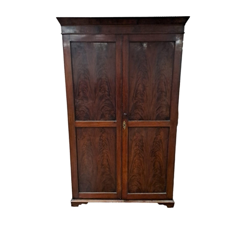 164 - A 19TH CENTURY MAHOGANY WARDROBE the moulded cornice above a pair of panel doors containing hanging ... 