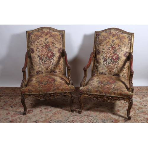 169 - A PAIR OF CONTINENTAL GILTWOOD AND UPHOLSTERED ARMCHAIRS the rectangular arched top rail above an up... 