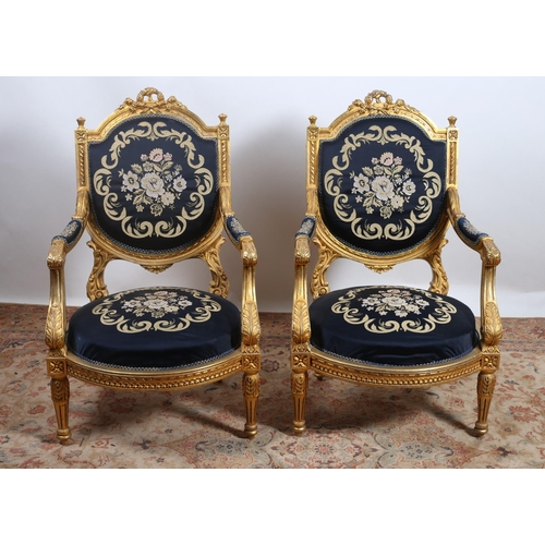 170 - A PAIR OF CONTINENTAL GILTWOOD AND NEEDLEWORK ARMCHAIRS each with a flowerhead and foliate carved cr... 