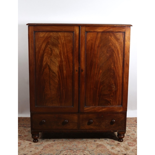 171 - A 19TH CENTURY MAHOGANY LINEN CUPBOARD of rectangular outline the shaped top above a pair of panel d... 