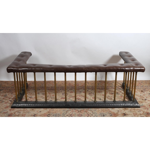 207 - A 19TH CENTURY BRASS CAST IRON AND HIDE UPHOLSTERED CLUB FENDER the U-shaped upholstered seat above ... 