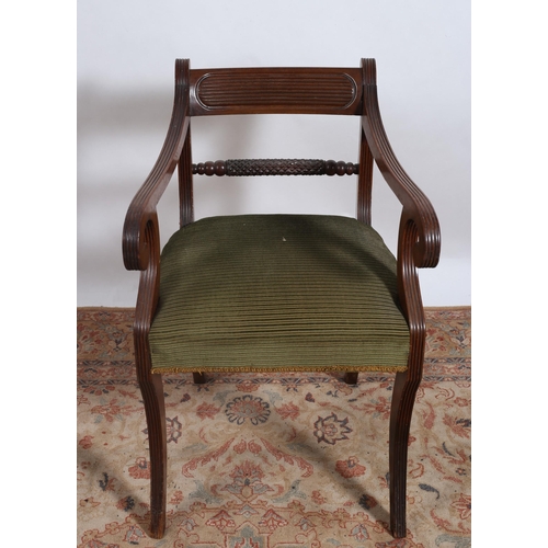 243 - A REGENCY MAHOGANY LIBRARY CHAIR the reeded top rail above a knopped carved splat with upholstered s... 