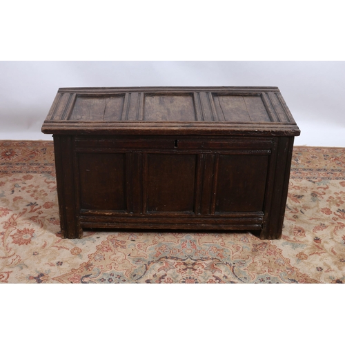 249 - A 19TH CENTURY OAK COFFER the rectangular hinged panel lid above a conforming frieze on moulded legs... 