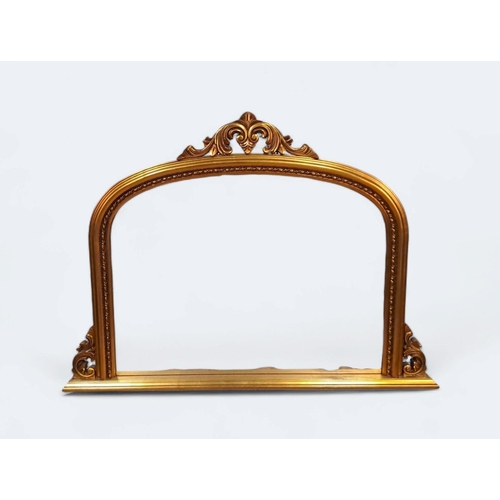 296 - A VICTORIAN STYLE GILT FRAME OVERMANTEL MIRROR the rectangular arched plate within a moulded frame w... 