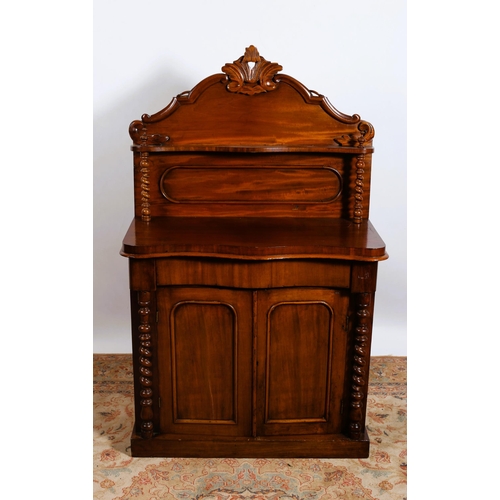 300 - A 19TH CENTURY MAHOGANY SIDE CABINET of serpentine outline the superstructure with carved and moulde... 