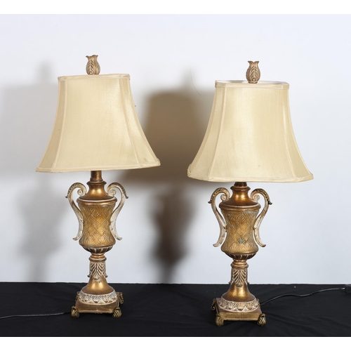 302 - **WITHDRAWN** A PAIR OF CONTINENTAL GILT AND PAINTED TABLE LAMPS each of urn form with pierced C-scr... 