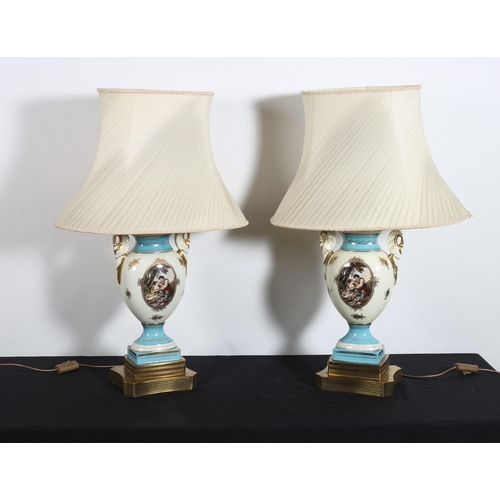 303 - **WITHDRAWN** A PAIR OF VICTORIAN STYLE PORCELAIN TABLE LAMPS each of vase form the white and gilt g... 