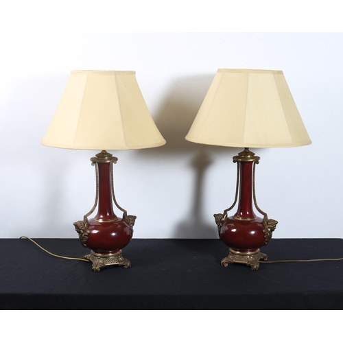 304 - **WITHDRAWN** A PAIR OF CONTINENTAL CHINA AND GILT BRASS TABLE LAMPS each of vase form with figural ... 