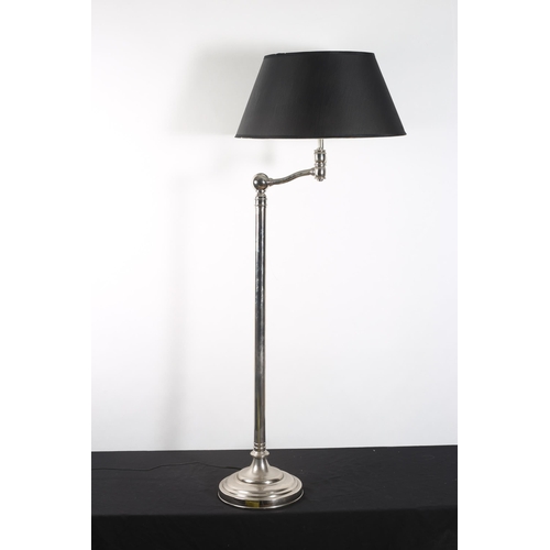 306 - A CHROME STANDARD READING LAMP the cylindrical column with adjustable arm raised on a circular sprea... 