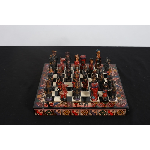 313 - A VINTAGE PERUVIAN CHESS SET Incas against Spanish Conquistadors in a folding chess board