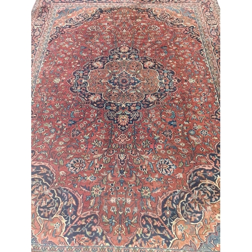 329 - A TABRIZ WOOL RUG the multicoloured ground with central panel filled with flowerheads and foliage wi... 