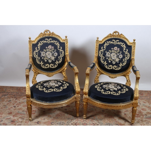 352 - A PAIR OF CONTINENTAL GILTWOOD AND NEEDLEWORK UPHOLSTERED ARMCHAIRS each with a pierced C-scroll flo... 