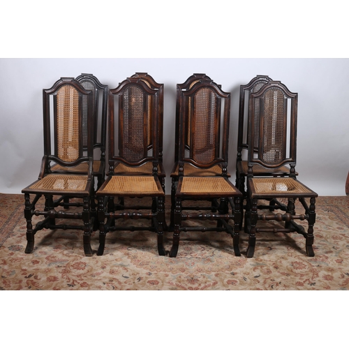 358 - A SET OF EIGHT VINTAGE STAINED WOOD AND CANED DINING CHAIRS each with a shaped top rail above a cane... 