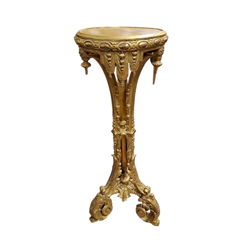 378 - A 19TH CENTURY GILTWOOD AND GESSO TORCHERE the circular dish top drapery and urn frieze raised on th... 