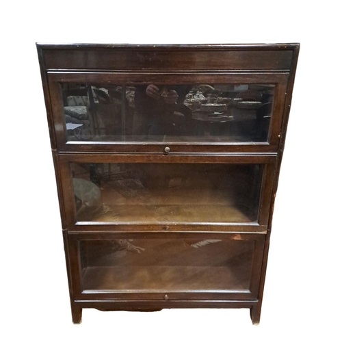 379 - A VINTAGE OAK STACKING BOOKCASE of rectangular outline with glazed hinged doors on moulded legs 
108... 