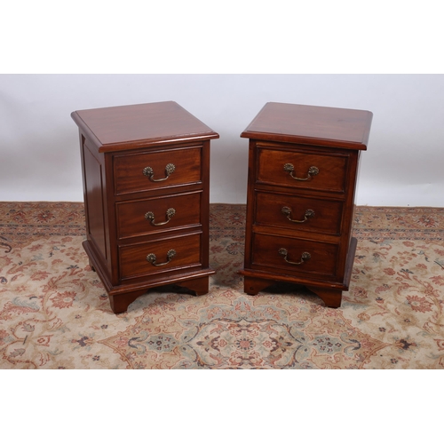 381 - A PAIR OF MAHOGANY BEDSIDE CHESTS each of rectangular outline the shaped tops with three frieze draw... 