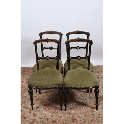 386 - A SET OF FOUR EDWARDIAN EBONISED AND GILT BRASS MOUNTED SIDE CHAIRS each with a curved top rail and ... 