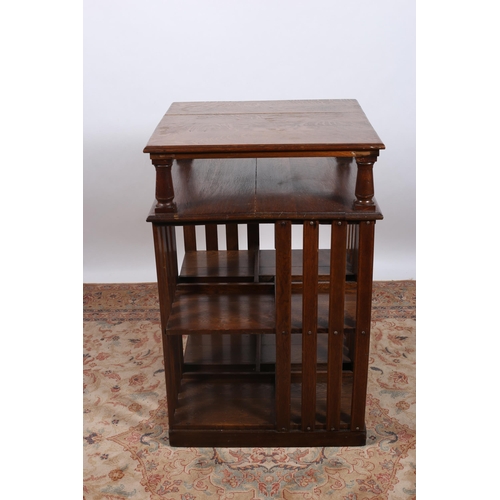 387 - AN EDWARDIAN OAK BOOKSTAND of square outline the shaped top above an open shelf with open compartmen... 