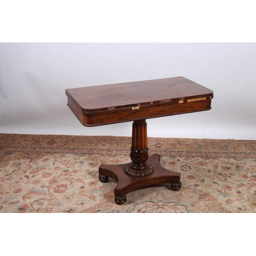 388 - A REGENCY ROSEWOOD FOLDOVER CARD TABLE the rectangular hinged top with baize lined interior above a ... 