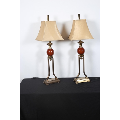 409 - **WITHDRAWN** A PAIR OF BRASS DESIGNER TABLE LAMPS each with a bulbous column raised on dual shaped ... 