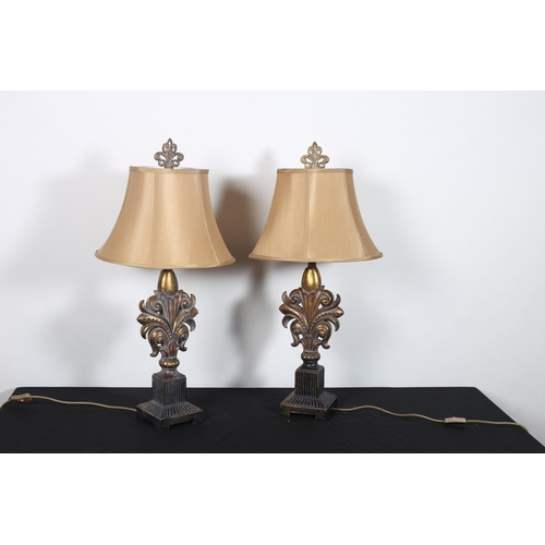 411 - **WITHDRAWN** A PAIR OF CONTINENTAL GILT TABLE LAMPS each with a pierced C-scroll and stylised folia... 