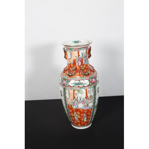 416 - AN IMARI STYLE VASE the white, light pink and green ground decorated with figures in an interior sce... 