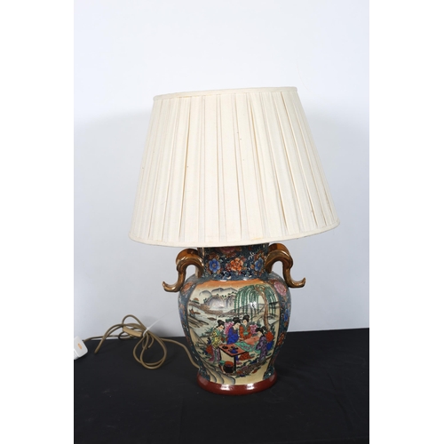 418 - A CHINESE TABLE LAMP of vase form the multicoloured ground decorated with figures seated around a ta... 