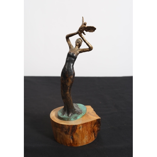 476 - A CAST BRONZE FIGURE modelled as a female dancer shown standing on a hardwood base 
23cm (h)