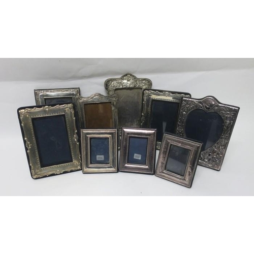 508 - A COLLECTION OF NINE SILVER EMBOSSED PHOTO FRAMES